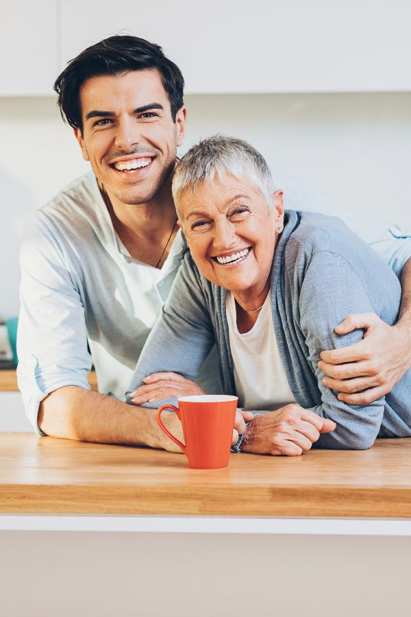image of a mother and son smiling together in their kitchen