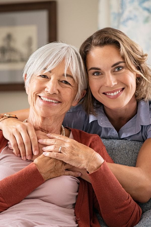 image of a mother and daughter smiling and embracing